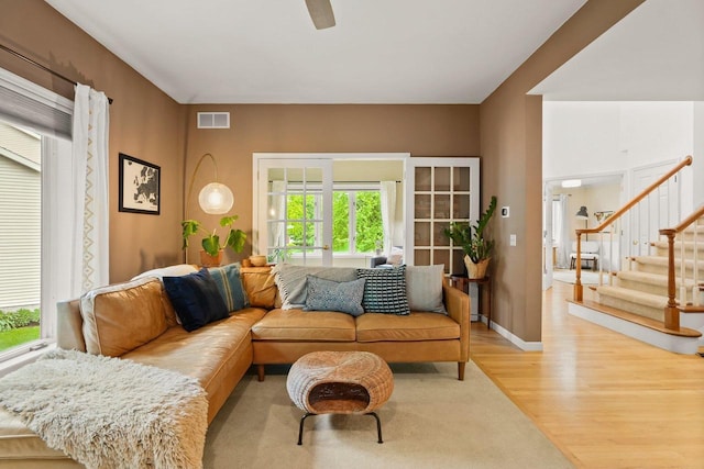956 Kingston Cir, Sun Prairie, WI 53590 - living area with wood finished floors, stairway, ceiling fan, and baseboards