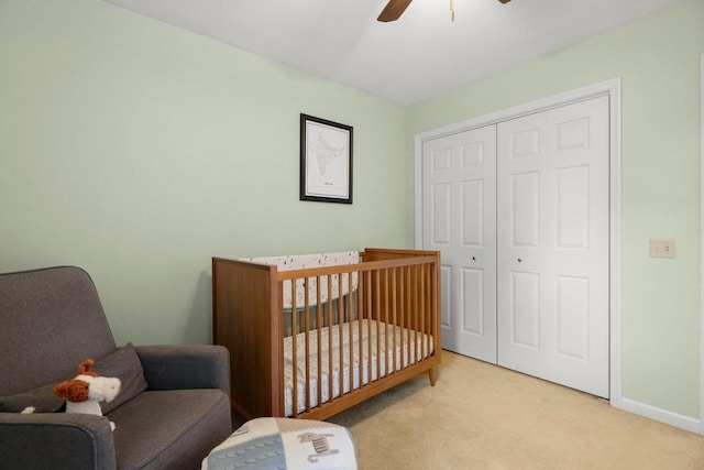 956 Kingston Cir, Sun Prairie, WI 53590 - bedroom with carpet flooring, a closet, a nursery area, a ceiling fan, and baseboards