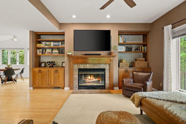 956 Kingston Cir, Sun Prairie, WI 53590 - living room with ceiling fan, light wood finished floors, a fireplace, recessed lighting, and built in features
