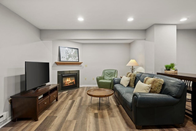 956 Kingston Cir, Sun Prairie, WI 53590 - living room featuring wood finished floors, recessed lighting, a fireplace with flush hearth, and baseboards