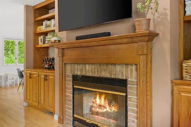956 Kingston Cir, Sun Prairie, WI 53590 - detailed view of a brick fireplace, wood finished floors, and backsplash