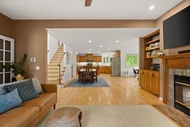 956 Kingston Cir, Sun Prairie, WI 53590 - living area featuring a brick fireplace, stairway, recessed lighting, and light wood finished floors