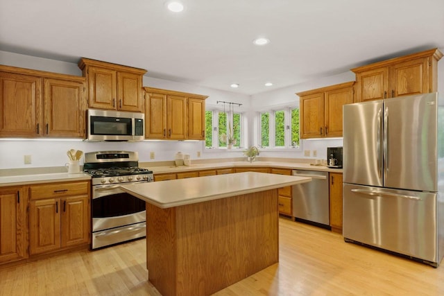 956 Kingston Cir, Sun Prairie, WI 53590 - kitchen with stainless steel appliances, light countertops, light wood-type flooring, and recessed lighting