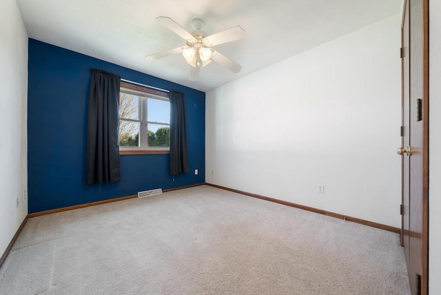 empty room featuring carpet, ceiling fan, and baseboards