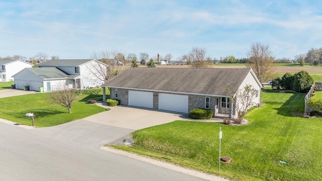 view of front of home featuring concrete driveway, a front yard, stone siding, and an attached garage