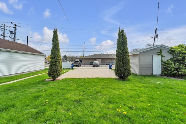 1235 Grove Ave, Racine, WI 53405 - view of green lawn with a patio area and an outbuilding