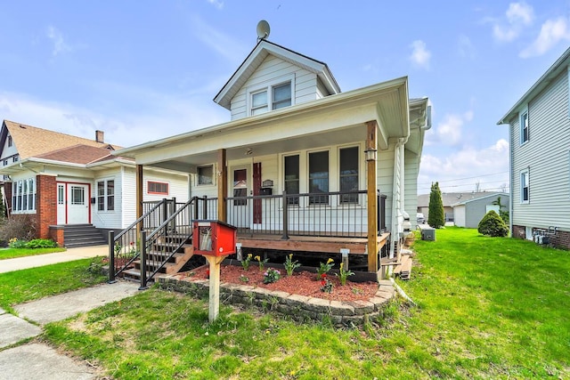1235 Grove Ave, Racine, WI 53405 - view of front of home with a front yard and a porch