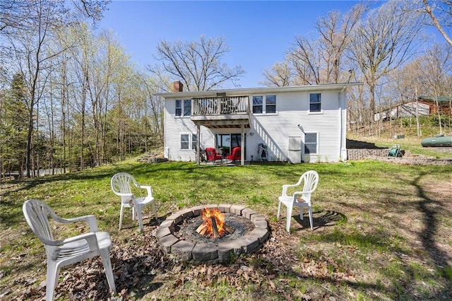 1141 134th Ave, Amery, WI 54001 - rear view of property with an outdoor fire pit, a chimney, a lawn, and a deck