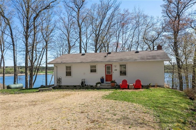 1141 134th Ave, Amery, WI 54001 - view of front facade featuring a chimney, a water view, and a front lawn