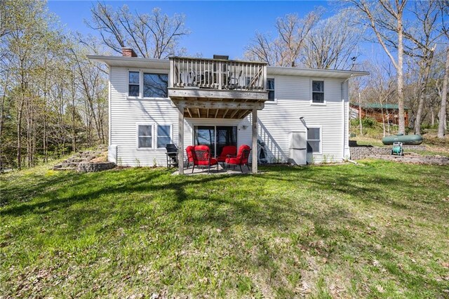 1141 134th Ave, Amery, WI 54001 - rear view of property featuring a lawn, a chimney, a wooden deck, and a patio