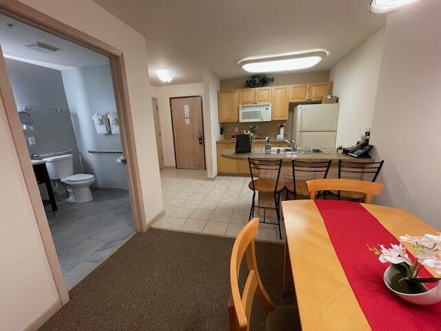 123 Center St Unit 101, Lake Geneva, WI 53147 - dining area featuring light tile patterned floors