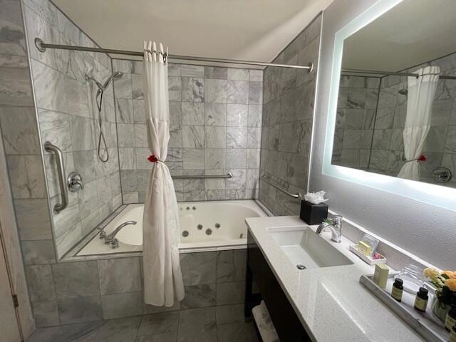 123 Center St Unit 101, Lake Geneva, WI 53147 - bathroom with a combined bath / shower with jetted tub, vanity, and tile patterned floors