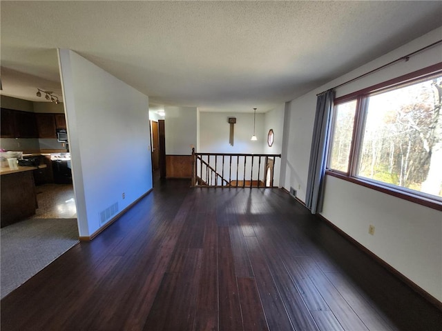 1451 90th Ave, Amery, WI 54001 - unfurnished room with dark wood-style floors, a textured ceiling, and baseboards