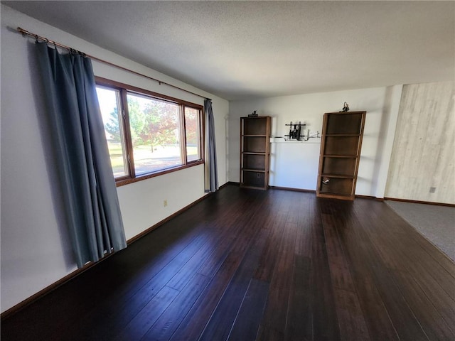 1451 90th Ave, Amery, WI 54001 - empty room featuring dark wood-style flooring and baseboards