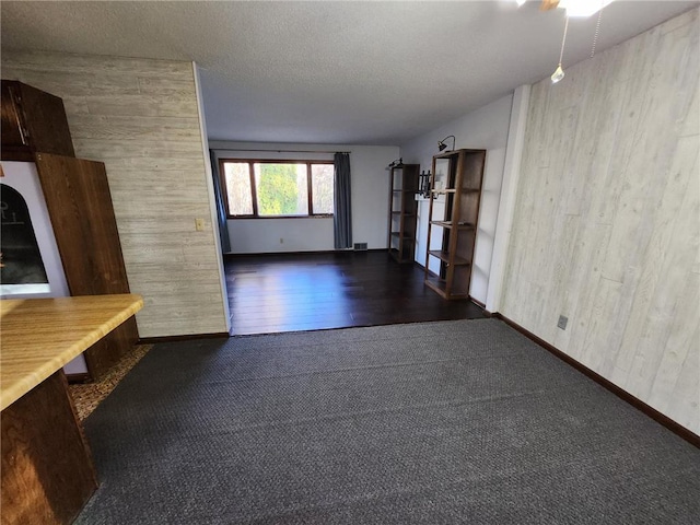 1451 90th Ave, Amery, WI 54001 - unfurnished living room with carpet floors, baseboards, and a textured ceiling