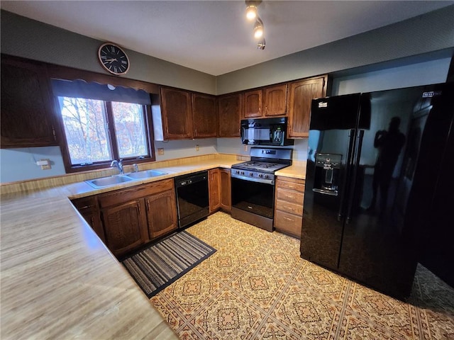 1451 90th Ave, Amery, WI 54001 - kitchen featuring black appliances, a sink, and light countertops