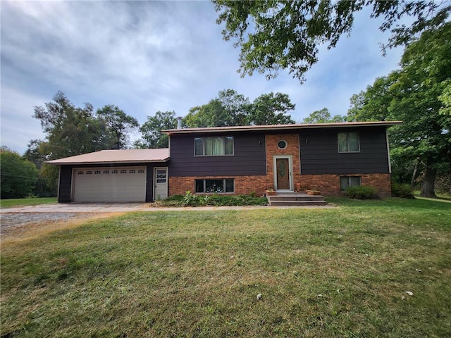 1451 90th Ave, Amery, WI 54001 - split foyer home with dirt driveway, an attached garage, a front yard, and brick siding