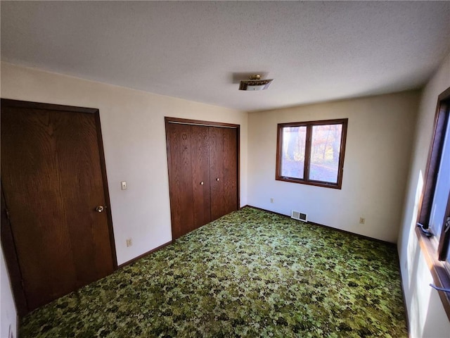 1451 90th Ave, Amery, WI 54001 - unfurnished bedroom featuring carpet floors, a closet, and baseboards