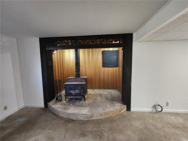 1451 90th Ave, Amery, WI 54001 - detailed view of a wood stove, baseboards, and concrete flooring