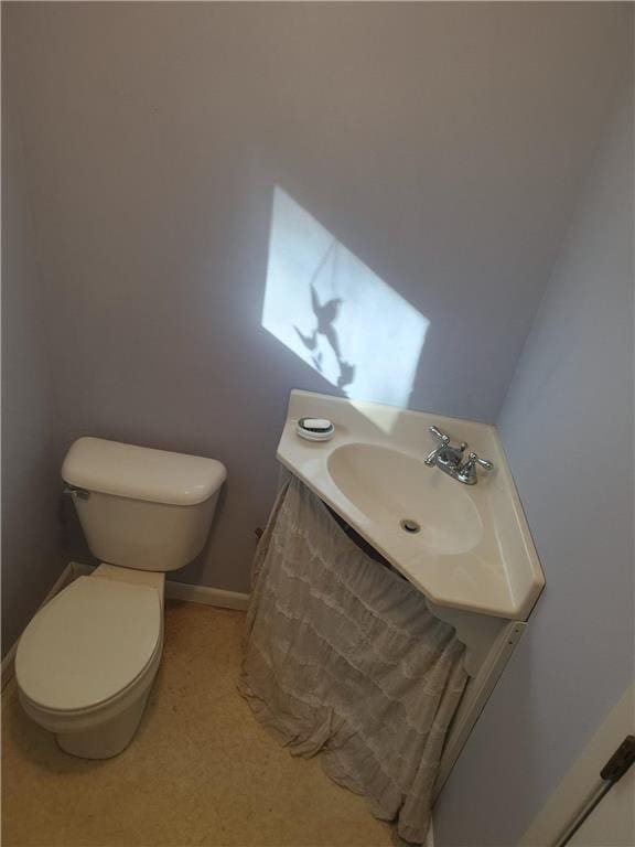 1451 90th Ave, Amery, WI 54001 - bathroom featuring toilet, vanity, and baseboards