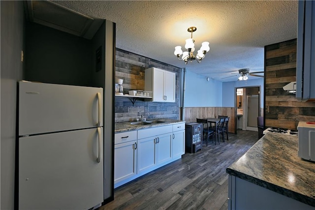 CABIN4 Gruenhagen Rd, Birchwood, WI 54817 - kitchen featuring freestanding refrigerator, a sink, wood walls, open shelves, and ceiling fan