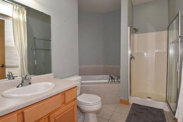110 S Wisconsin St Unit 2E, Port Washington, WI 53074 - full bathroom featuring a stall shower, tile patterned flooring, a garden tub, vanity, and toilet