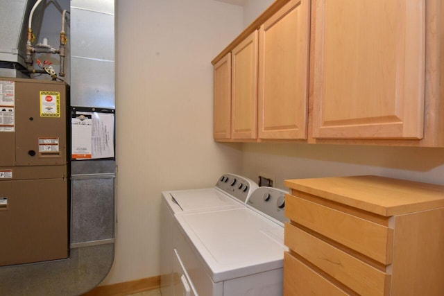 110 S Wisconsin St Unit 2E, Port Washington, WI 53074 - laundry room featuring washer and clothes dryer, cabinet space, heating unit, and baseboards