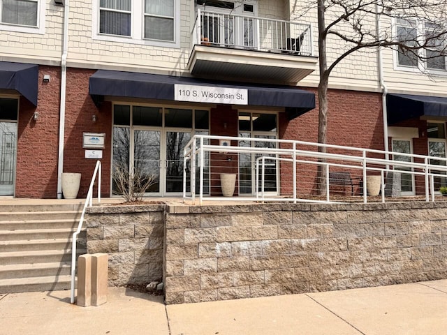 110 S Wisconsin St Unit 2E, Port Washington, WI 53074 - doorway to property with brick siding