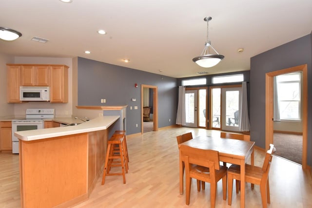 110 S Wisconsin St Unit 2E, Port Washington, WI 53074 - dining space with light wood-style flooring, recessed lighting, and baseboards
