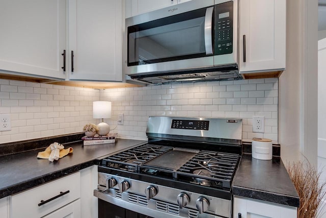 932 Washburn St, Beloit, WI 53511 - kitchen with stainless steel appliances, white cabinetry, dark countertops, and decorative backsplash