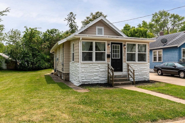 932 Washburn St, Beloit, WI 53511 - bungalow with entry steps, stone siding, and a front lawn