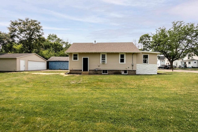 932 Washburn St, Beloit, WI 53511 - back of property with a garage, an outbuilding, a lawn, and entry steps