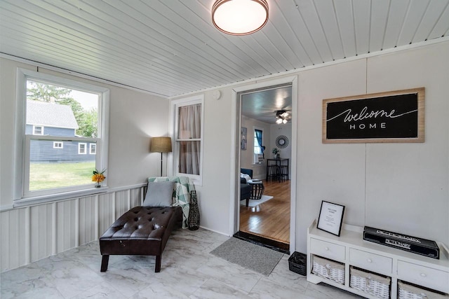 932 Washburn St, Beloit, WI 53511 - living area featuring healthy amount of natural light, wooden ceiling, marble look tiles, and a ceiling fan
