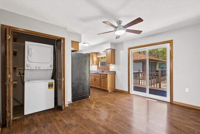 7224 Dartmoor Ave, Greendale, WI 53129 - clothes washing area featuring stacked washing machine and dryer, dark wood-style floors, baseboards, and a ceiling fan