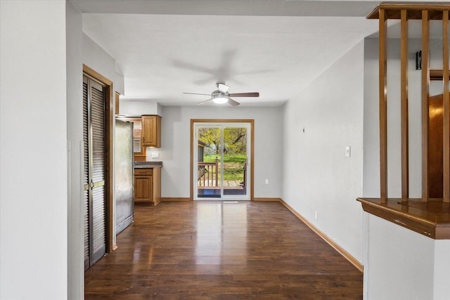 7224 Dartmoor Ave, Greendale, WI 53129 - unfurnished dining area with dark wood-style flooring, a ceiling fan, and baseboards
