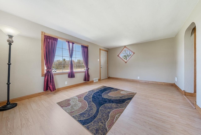 2780 Humboldt Rd, Green Bay, WI 54311 - spare room featuring plenty of natural light, wood finished floors, baseboards, and arched walkways