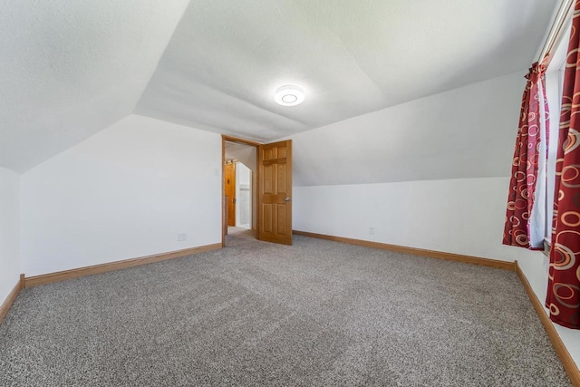 2780 Humboldt Rd, Green Bay, WI 54311 - bonus room with vaulted ceiling, carpet flooring, baseboards, and a textured ceiling