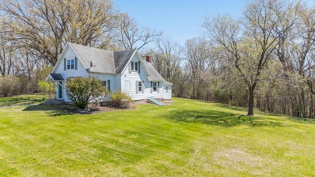 2780 Humboldt Rd, Green Bay, WI 54311 - view of home's exterior with a chimney, a lawn, and a shingled roof