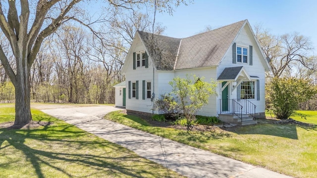 2780 Humboldt Rd, Green Bay, WI 54311 - view of front of home featuring a shingled roof, concrete driveway, and a front lawn