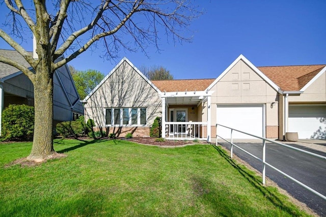7910 N Brookline Dr, Madison, WI 53719 - view of front facade with asphalt driveway, a garage, a front yard, stucco siding, and a shingled roof