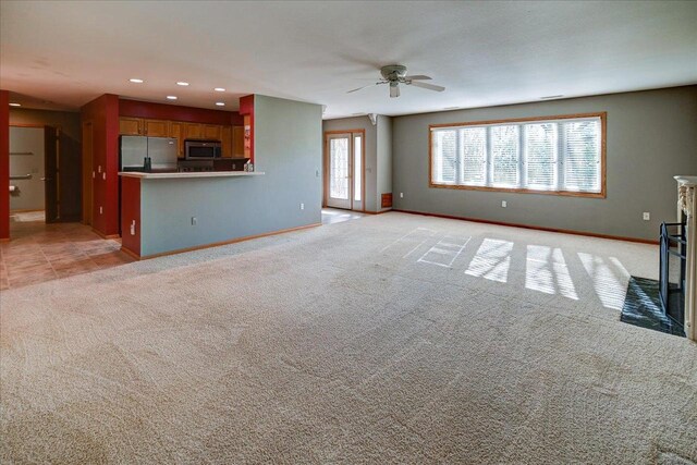 7910 N Brookline Dr, Madison, WI 53719 - unfurnished living room with light carpet, baseboards, a ceiling fan, and recessed lighting