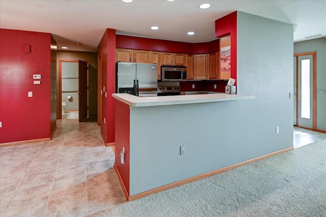 7910 N Brookline Dr, Madison, WI 53719 - kitchen featuring appliances with stainless steel finishes, light countertops, recessed lighting, brown cabinets, and baseboards