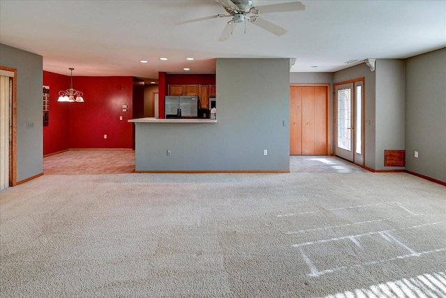 7910 N Brookline Dr, Madison, WI 53719 - unfurnished living room with light carpet, baseboards, ceiling fan, recessed lighting, and a chandelier
