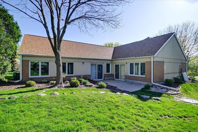 7910 N Brookline Dr, Madison, WI 53719 - rear view of property with brick siding, a patio area, a yard, and a shingled roof