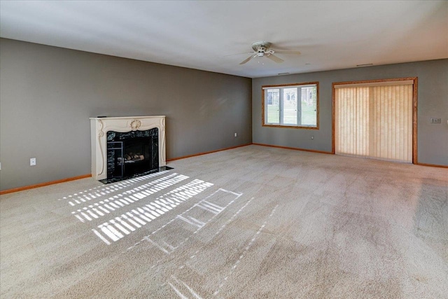 7910 N Brookline Dr, Madison, WI 53719 - unfurnished living room with a ceiling fan, baseboards, carpet flooring, and a premium fireplace