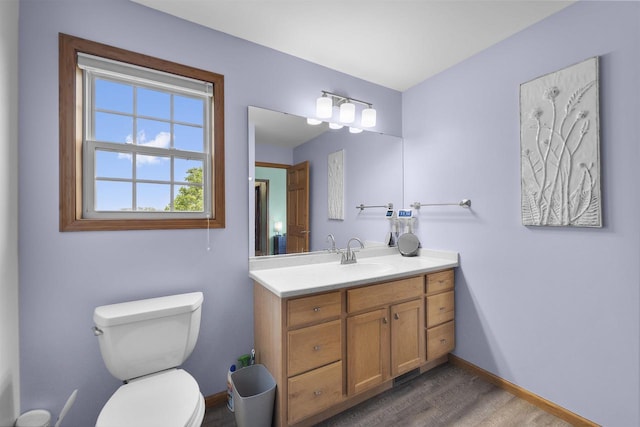 575 Fargo Trl, Middleton, WI 53562 - bathroom with wood finished floors, toilet, vanity, and baseboards