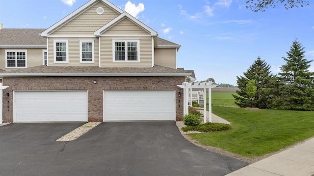 575 Fargo Trl, Middleton, WI 53562 - traditional home featuring driveway, brick siding, a front yard, an attached garage, and roof with shingles
