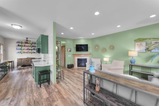 575 Fargo Trl, Middleton, WI 53562 - living area with wood finished floors, a glass covered fireplace, and recessed lighting