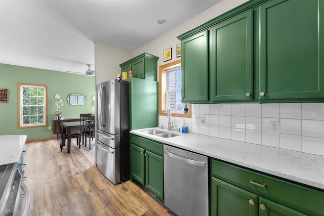 575 Fargo Trl, Middleton, WI 53562 - kitchen with appliances with stainless steel finishes, a sink, green cabinets, and plenty of natural light