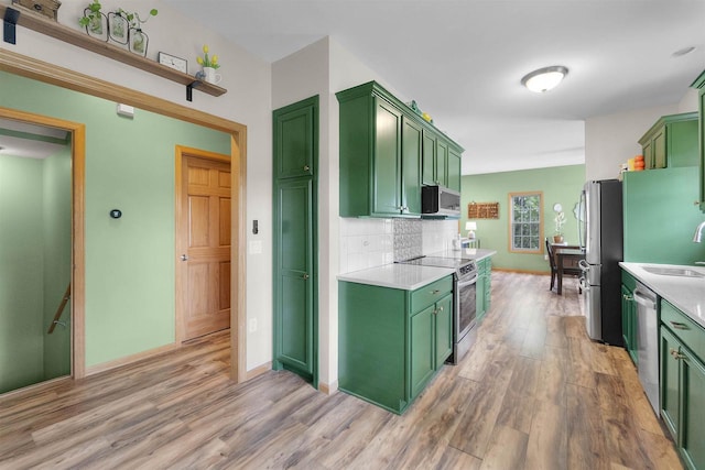 575 Fargo Trl, Middleton, WI 53562 - kitchen with green cabinetry, appliances with stainless steel finishes, light wood-style floors, and light countertops